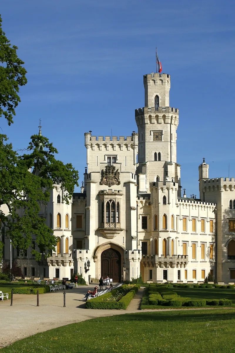 The white neo-Gothic towers of Hluboká Castle above its terraced gardens and the Vltava valley in South Bohemia